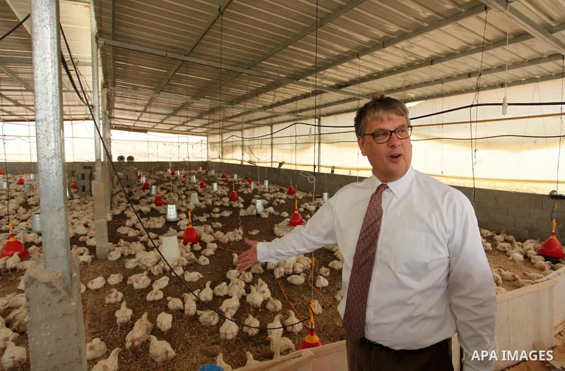 Representative for the Netherlands to the Palestinian Authority Peter Mollema gestures as he visits a chicken farm supplied with water that is provided by a Dutch-funded project, in Khan Younis in the southern Gaza Strip...