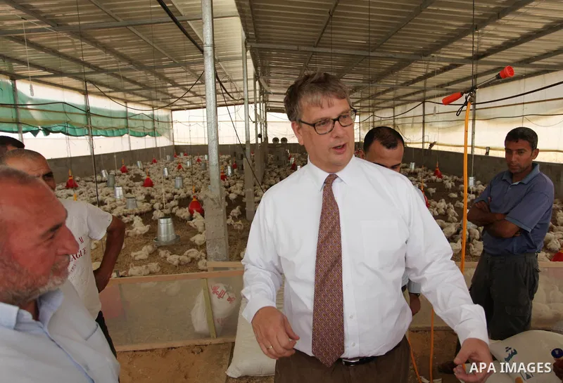 Representative for the Netherlands to the Palestinian Authority Peter Mollema gestures as he visits a chicken farm supplied with water that is provided by a Dutch-funded project, in Khan Younis in the southern Gaza Strip...