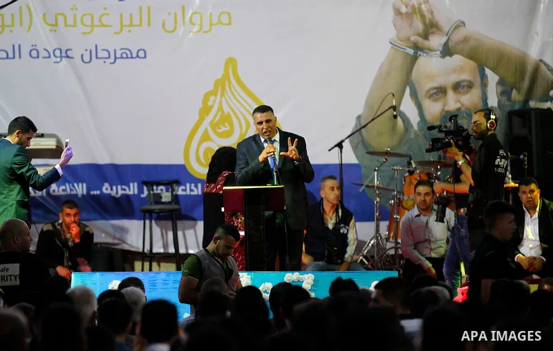 Palestinians take part in a opening ceremony of al-Hurria radio broadcasting office after the closure by the Israeli military, in the West Bank city of Hebron, on May 1, 2016. Photo by Wisam Hashlamoun