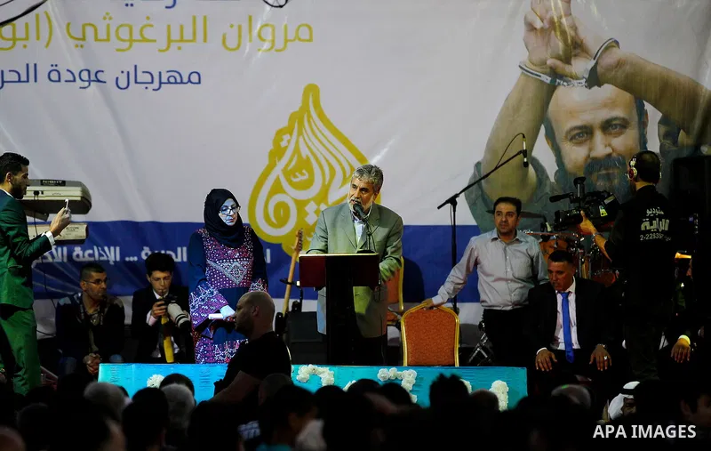 Palestinians take part in a opening ceremony of al-Hurria radio broadcasting office after the closure by the Israeli military, in the West Bank city of Hebron, on May 1, 2016. Photo by Wisam Hashlamoun