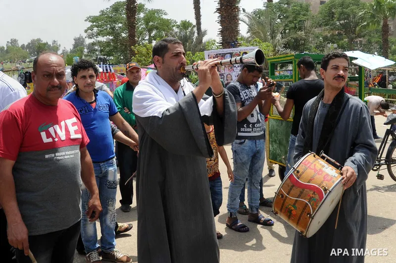Egyptian musicians perform at a garden marking Sham el-Nessim, or smelling the breeze which marks the beginning of spring, in Cairo, on May 02, 2016. Photo by Amr Sayed