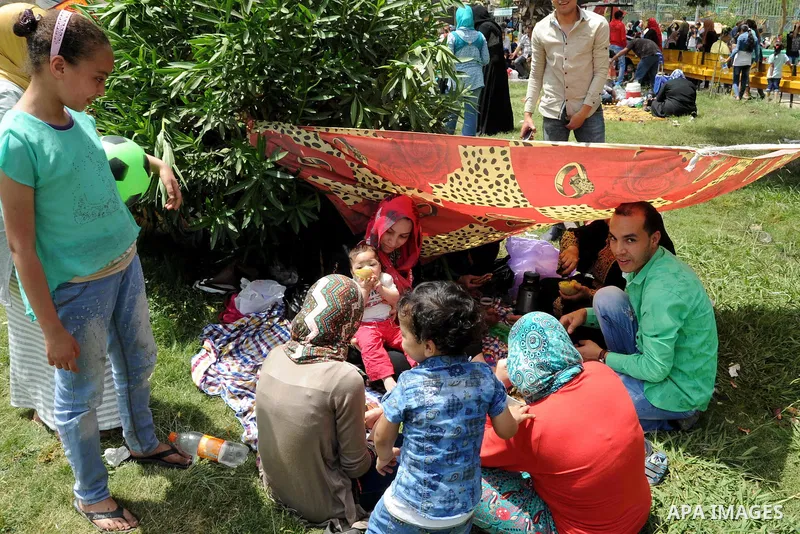 Egyptians gather at a garden marking Sham el-Nessim, or smelling the breeze which marks the beginning of spring, in Cairo, on May 02, 2016. Photo by Amr Sayed
