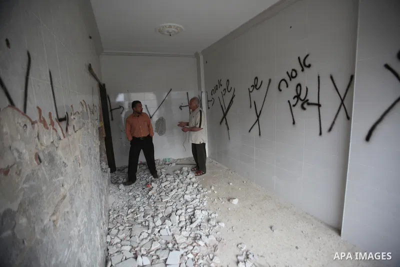 Palestinians look at the damage in the West Bank city of Nablus on May 3, 2016, after Israeli forces destroyed the house of Zaid Amer, a Palestinian man accused of taking part in the killing of a Jewish settler couple ne...