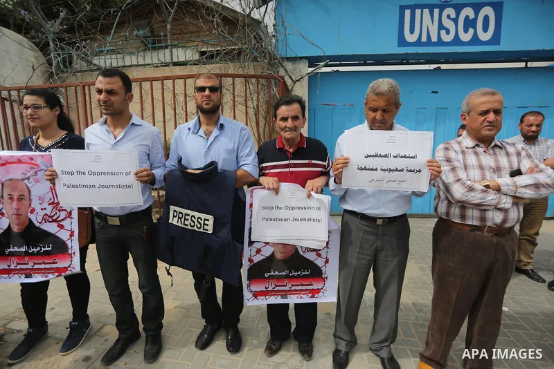 Palestinian Journalists hold banners during a protest calling for stop the Israeli violence against journalists to mark the World Press Freedom Day, in front of the headquarter United Nation "UNSCO" in Gaza City, on May...