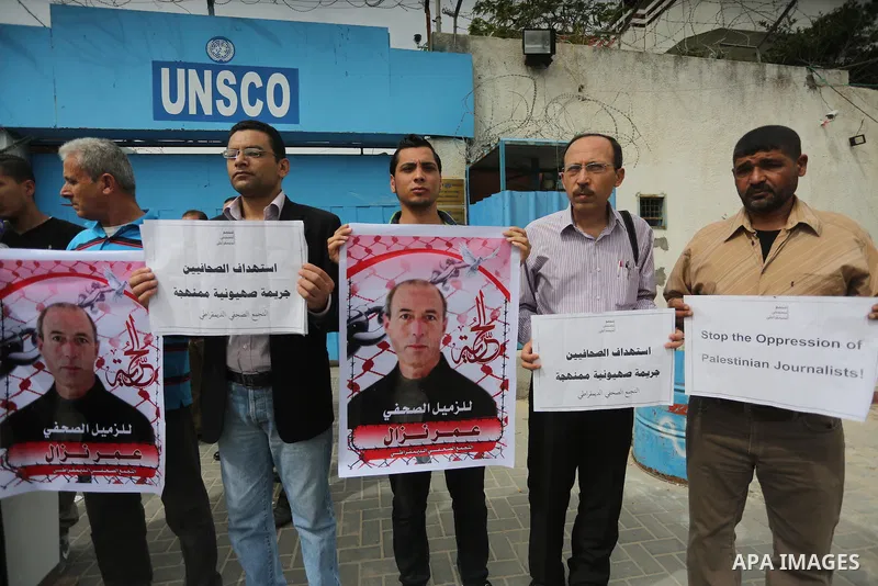 Palestinian Journalists hold banners during a protest calling for stop the Israeli violence against journalists to mark the World Press Freedom Day, in front of the headquarter United Nation "UNSCO" in Gaza City, on May...
