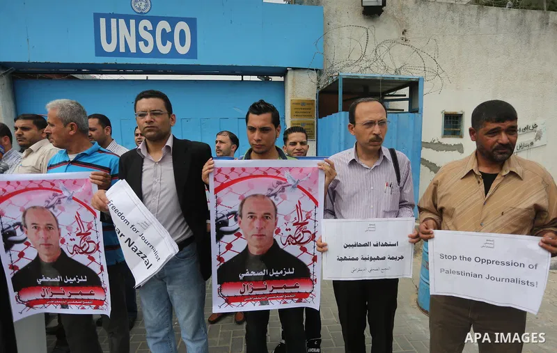Palestinian Journalists hold banners during a protest calling for stop the Israeli violence against journalists to mark the World Press Freedom Day, in front of the headquarter United Nation "UNSCO" in Gaza City, on May...