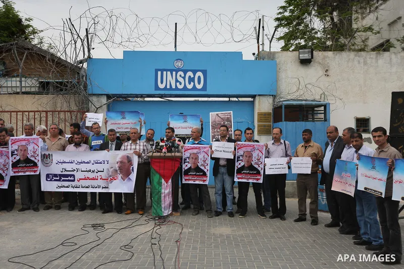 Palestinian Journalists hold banners during a protest calling for stop the Israeli violence against journalists to mark the World Press Freedom Day, in front of the headquarter United Nation "UNSCO" in Gaza City, on May...