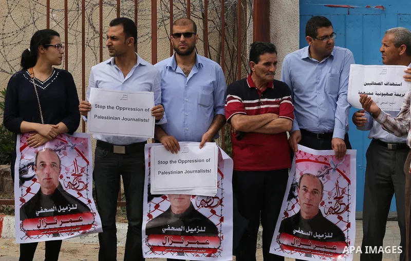 Palestinian Journalists hold banners during a protest calling for stop the Israeli violence against journalists to mark the World Press Freedom Day, in front of the headquarter United Nation "UNSCO" in Gaza City, on May...
