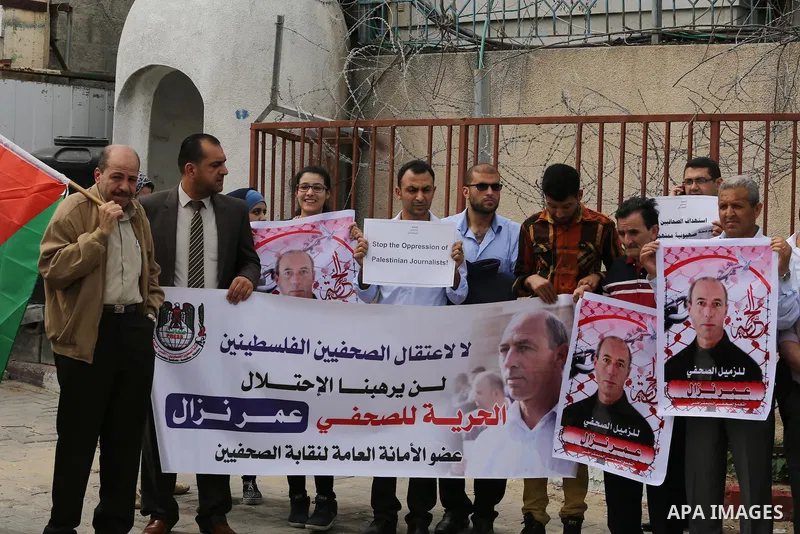 Palestinian Journalists hold banners during a protest calling for stop the Israeli violence against journalists to mark the World Press Freedom Day, in front of the headquarter United Nation "UNSCO" in Gaza City, on May...