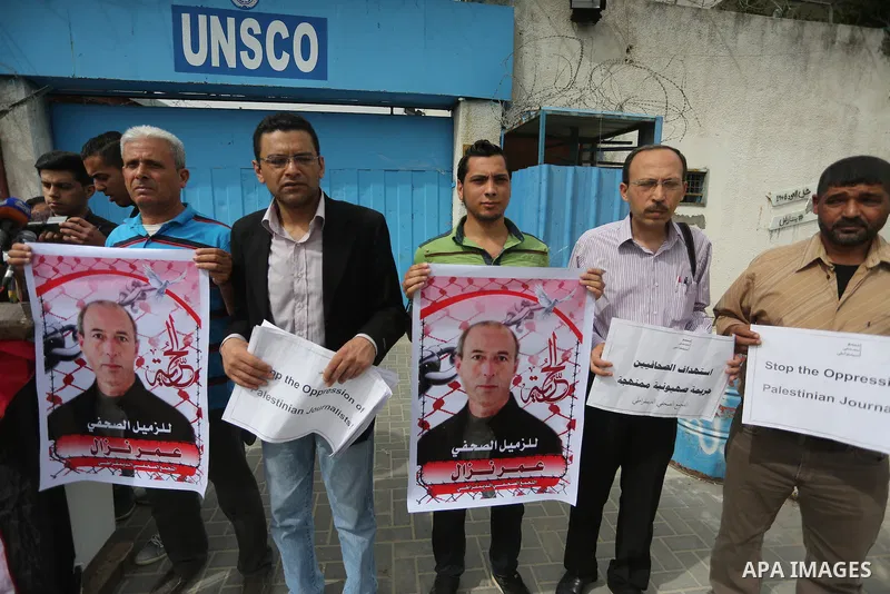 Palestinian Journalists hold banners during a protest calling for stop the Israeli violence against journalists to mark the World Press Freedom Day, in front of the headquarter United Nation "UNSCO" in Gaza City, on May...