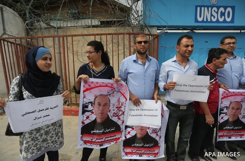 Palestinian Journalists hold banners during a protest calling for stop the Israeli violence against journalists to mark the World Press Freedom Day, in front of the headquarter United Nation "UNSCO" in Gaza City, on May...
