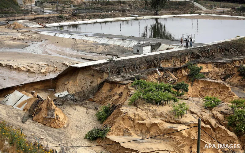 Palestinians inspect the damage following the collapse one of sewage basins in the Zeitoun neighborhood, in Gaza city, on May 03, 2016. Photo by Mohammed Asad