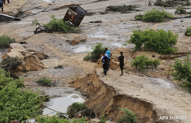 Palestinians inspect the damage following the collapse one of sewage basins in the Zeitoun neighborhood, in Gaza city, on May 03, 2016. Photo by Mohammed Asad