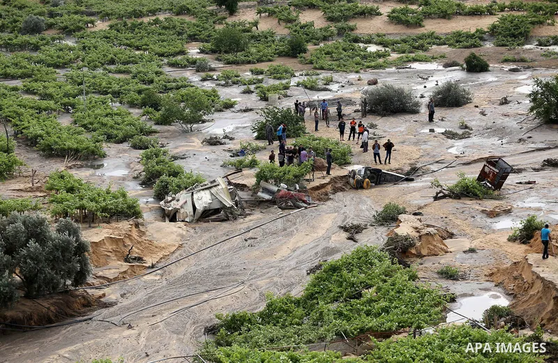 Palestinians inspect the damage following the collapse one of sewage basins in the Zeitoun neighborhood, in Gaza city, on May 03, 2016. Photo by Mohammed Asad