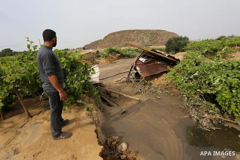 Palestinians inspect the damage following the collapse one of sewage basins in the Zeitoun neighborhood, in Gaza city, on May 03, 2016. Photo by Mohammed Asad