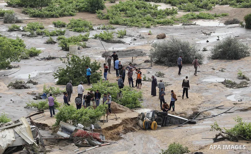 Palestinians inspect the damage following the collapse one of sewage basins in the Zeitoun neighborhood, in Gaza city, on May 03, 2016. Photo by Mohammed Asad