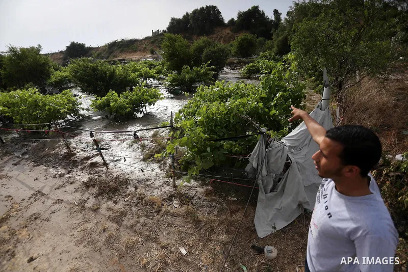 Palestinians inspect the damage following the collapse one of sewage basins in the Zeitoun neighborhood, in Gaza city, on May 03, 2016. Photo by Mohammed Asad