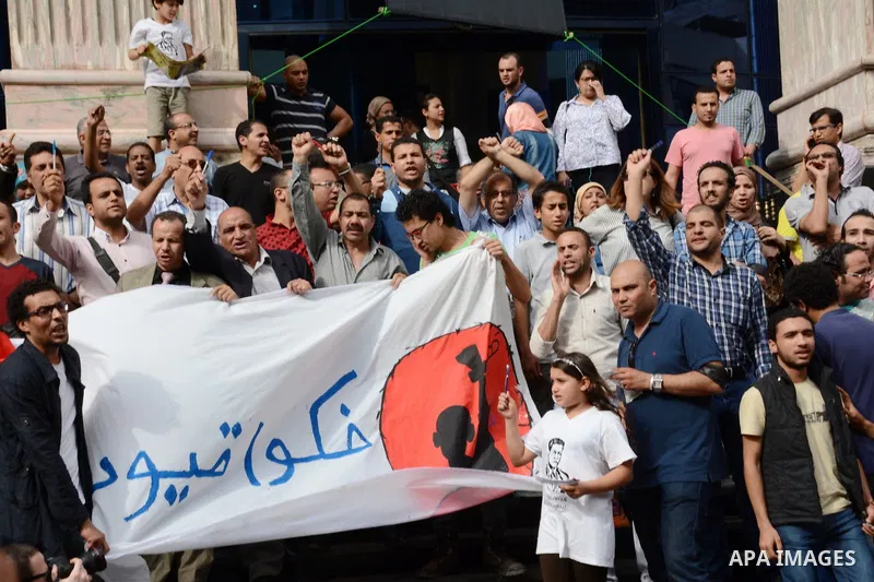 Egyptian Journalists take part during a protest against the arrests of fellow journalists outside the Egyptian Journalist syndicate headquarters in the capital Cairo on May 3, 2016 on the occasion of World Press Freedom...