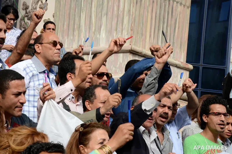 Egyptian Journalists take part during a protest against the arrests of fellow journalists outside the Egyptian Journalist syndicate headquarters in the capital Cairo on May 3, 2016 on the occasion of World Press Freedom...