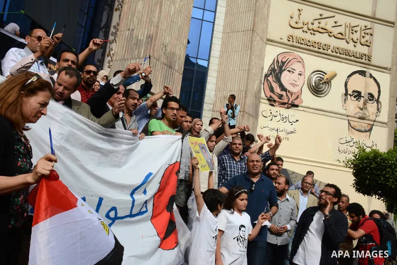 Egyptian Journalists take part during a protest against the arrests of fellow journalists outside the Egyptian Journalist syndicate headquarters in the capital Cairo on May 3, 2016 on the occasion of World Press Freedom...