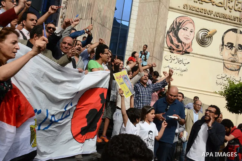 Egyptian Journalists take part during a protest against the arrests of fellow journalists outside the Egyptian Journalist syndicate headquarters in the capital Cairo on May 3, 2016 on the occasion of World Press Freedom...