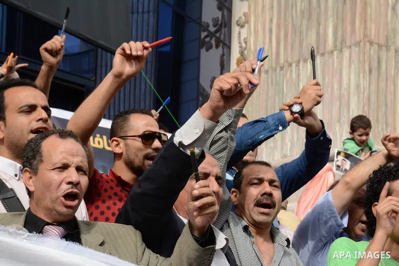 Egyptian Journalists take part during a protest against the arrests of fellow journalists outside the Egyptian Journalist syndicate headquarters in the capital Cairo on May 3, 2016 on the occasion of World Press Freedom...