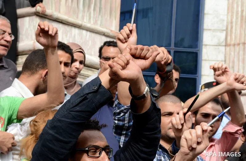Egyptian Journalists take part during a protest against the arrests of fellow journalists outside the Egyptian Journalist syndicate headquarters in the capital Cairo on May 3, 2016 on the occasion of World Press Freedom...