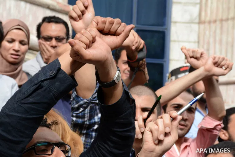 Egyptian Journalists take part during a protest against the arrests of fellow journalists outside the Egyptian Journalist syndicate headquarters in the capital Cairo on May 3, 2016 on the occasion of World Press Freedom...
