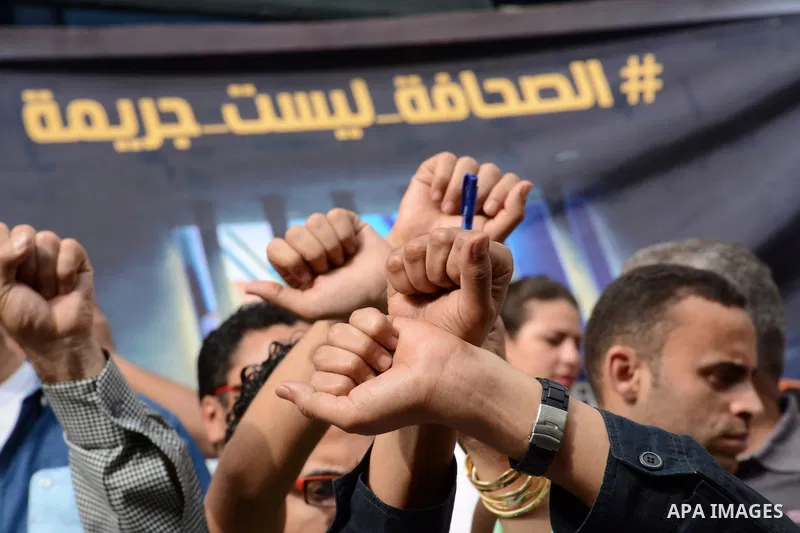 Egyptian Journalists take part during a protest against the arrests of fellow journalists outside the Egyptian Journalist syndicate headquarters in the capital Cairo on May 3, 2016 on the occasion of World Press Freedom...