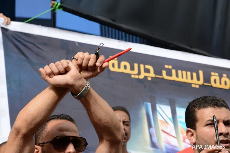 Egyptian Journalists take part during a protest against the arrests of fellow journalists outside the Egyptian Journalist syndicate headquarters in the capital Cairo on May 3, 2016 on the occasion of World Press Freedom...