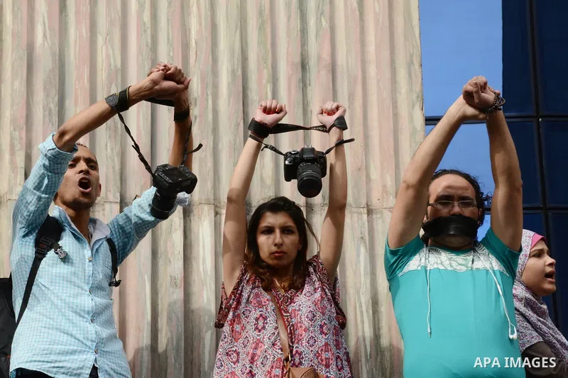 Egyptian Journalists take part during a protest against the arrests of fellow journalists outside the Egyptian Journalist syndicate headquarters in the capital Cairo on May 3, 2016 on the occasion of World Press Freedom...