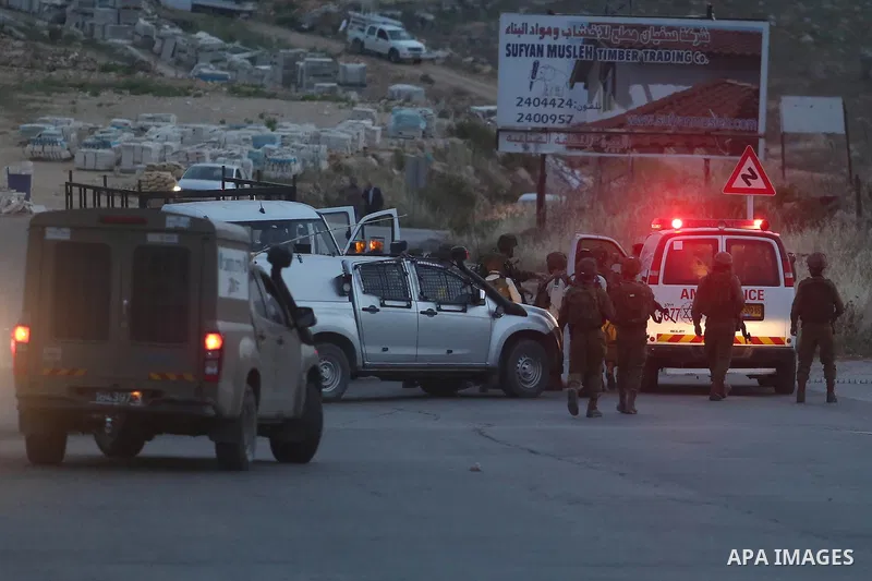 Israeli soldier gather at the scene where a Palestinian, who the Israeli military said rammed his car into three Israeli soldiers, was shot dead by Israeli troops near Beituniya near the West Bank city of Ramallah May 3,...