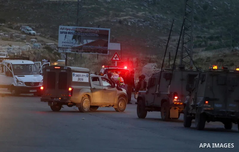 Israeli soldier gather at the scene where a Palestinian, who the Israeli military said rammed his car into three Israeli soldiers, was shot dead by Israeli troops near Beituniya near the West Bank city of Ramallah May 3,...