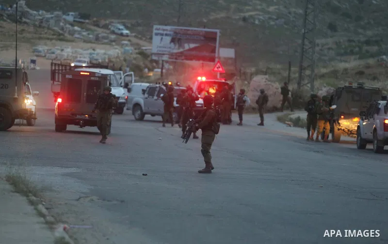 Israeli soldier gather at the scene where a Palestinian, who the Israeli military said rammed his car into three Israeli soldiers, was shot dead by Israeli troops near Beituniya near the West Bank city of Ramallah May 3,...