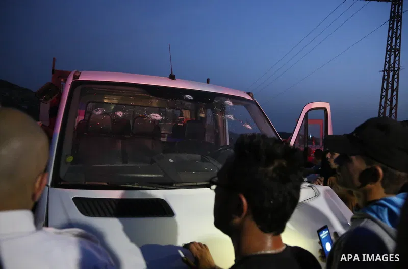 Palestinian men inspect a vehicle with a bullet shattered windshield at the scene where a Palestinian, who the Israeli military said rammed his car into three Israeli soldiers, was shot dead by Israeli troops near Beitun...