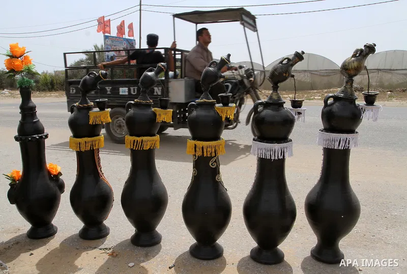 A Palestinian man displays handmade vases from pottery, Rafah in the Southern Gaza strip, on May 4, 2016. According to human rights reports, the ongoing Israeli blockade undermines development in all aspects of Palestini...