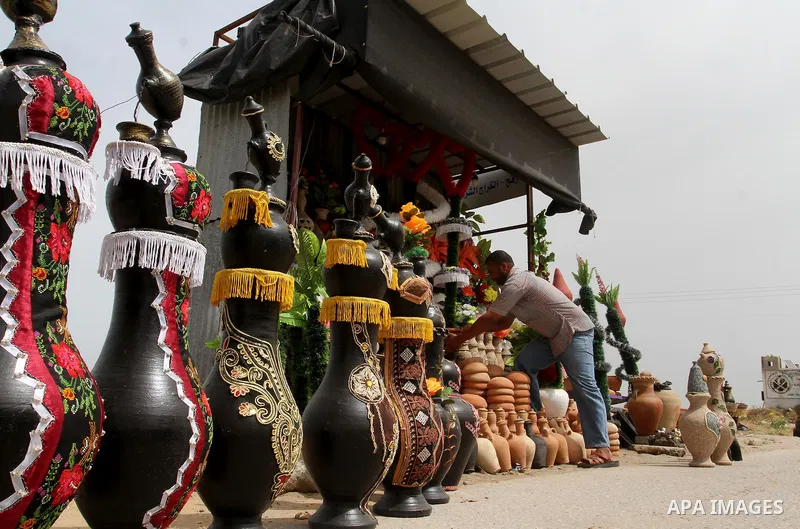 A Palestinian man displays handmade vases from pottery, Rafah in the Southern Gaza strip, on May 4, 2016. According to human rights reports, the ongoing Israeli blockade undermines development in all aspects of Palestini...