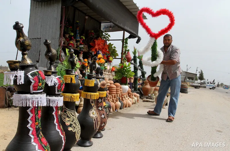 A Palestinian man displays handmade vases from pottery, Rafah in the Southern Gaza strip, on May 4, 2016. According to human rights reports, the ongoing Israeli blockade undermines development in all aspects of Palestini...
