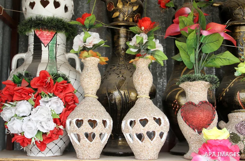A Palestinian man displays handmade vases from pottery, Rafah in the Southern Gaza strip, on May 4, 2016. According to human rights reports, the ongoing Israeli blockade undermines development in all aspects of Palestini...