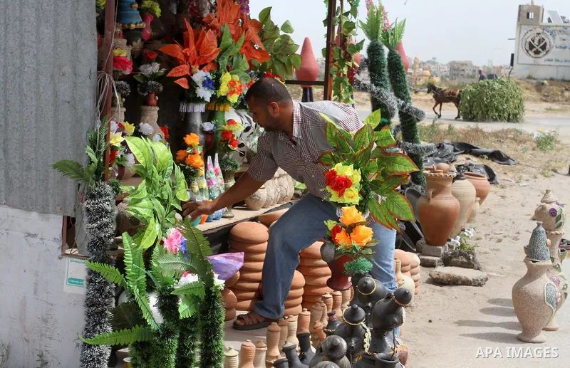 A Palestinian man displays handmade vases from pottery, Rafah in the Southern Gaza strip, on May 4, 2016. According to human rights reports, the ongoing Israeli blockade undermines development in all aspects of Palestini...