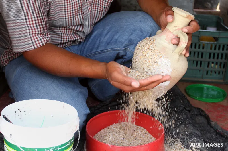 A Palestinian man displays handmade vases from pottery, Rafah in the Southern Gaza strip, on May 4, 2016. According to human rights reports, the ongoing Israeli blockade undermines development in all aspects of Palestini...
