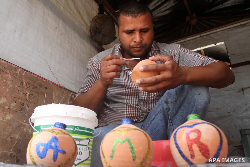 A Palestinian man displays handmade vases from pottery, Rafah in the Southern Gaza strip, on May 4, 2016. According to human rights reports, the ongoing Israeli blockade undermines development in all aspects of Palestini...