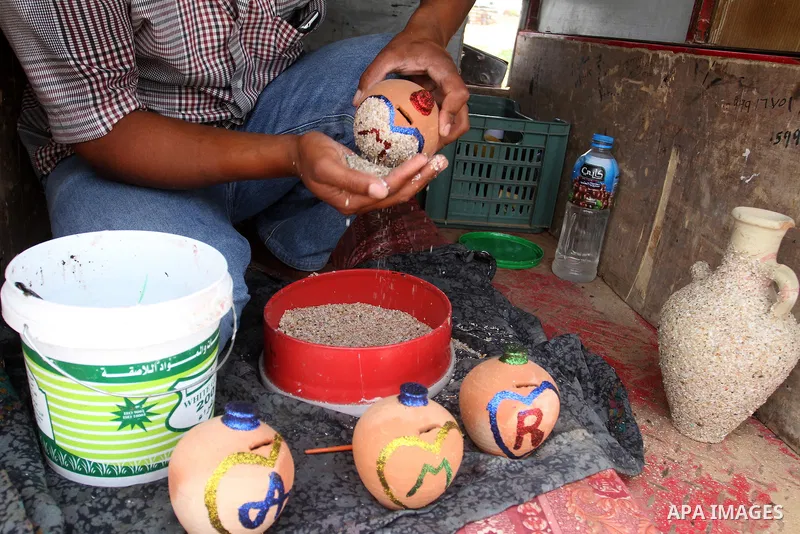 A Palestinian man displays handmade vases from pottery, Rafah in the Southern Gaza strip, on May 4, 2016. According to human rights reports, the ongoing Israeli blockade undermines development in all aspects of Palestini...
