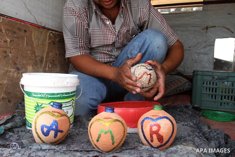 A Palestinian man displays handmade vases from pottery, Rafah in the Southern Gaza strip, on May 4, 2016. According to human rights reports, the ongoing Israeli blockade undermines development in all aspects of Palestini...