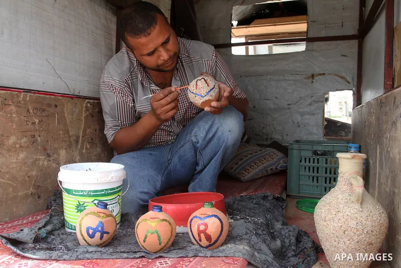 A Palestinian man displays handmade vases from pottery, Rafah in the Southern Gaza strip, on May 4, 2016. According to human rights reports, the ongoing Israeli blockade undermines development in all aspects of Palestini...