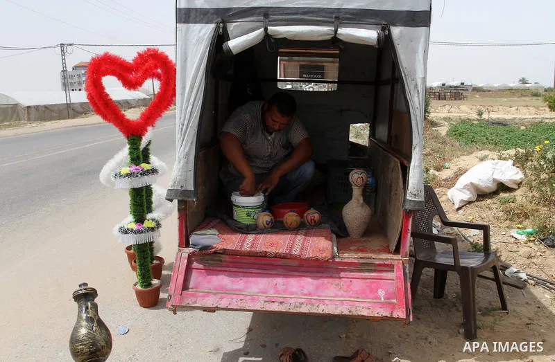 A Palestinian man displays handmade vases from pottery, Rafah in the Southern Gaza strip, on May 4, 2016. According to human rights reports, the ongoing Israeli blockade undermines development in all aspects of Palestini...