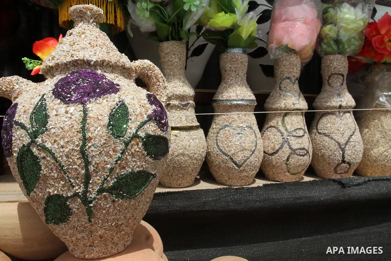 A Palestinian man displays handmade vases from pottery, Rafah in the Southern Gaza strip, on May 4, 2016. According to human rights reports, the ongoing Israeli blockade undermines development in all aspects of Palestini...