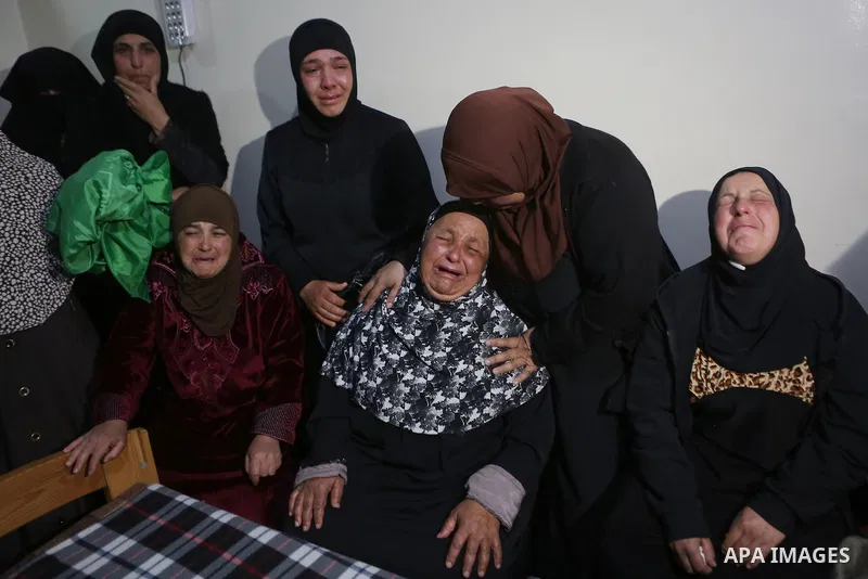 Relatives of Palestinian Ahmed Reyad Shehada, 36, whom the Israeli army said was shot dead by Israeli troops after ramming his vehicle into three Israeli soldiers, mourn during his funeral in Bitunia near the West Bank c...