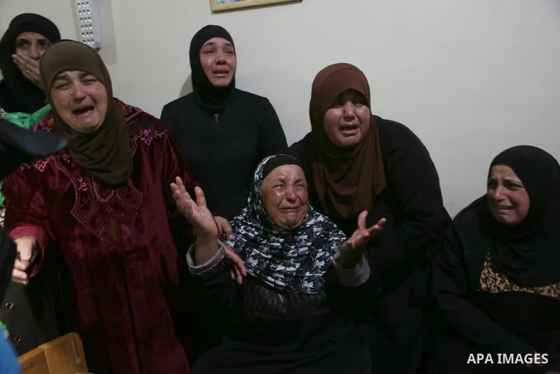 Relatives of Palestinian Ahmed Reyad Shehada, 36, whom the Israeli army said was shot dead by Israeli troops after ramming his vehicle into three Israeli soldiers, mourn during his funeral in Bitunia near the West Bank c...