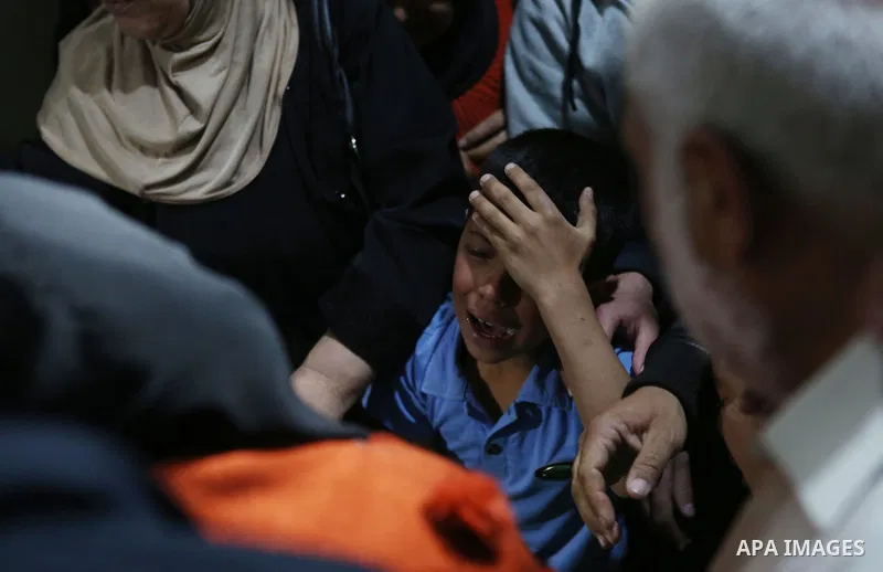 Relatives of Palestinian Ahmed Reyad Shehada, 36, whom the Israeli army said was shot dead by Israeli troops after ramming his vehicle into three Israeli soldiers, mourn during his funeral in Bitunia near the West Bank c...